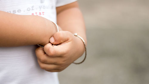 Midsection of doctor holding tape measure