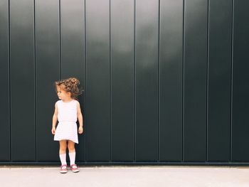 Boy standing against wall