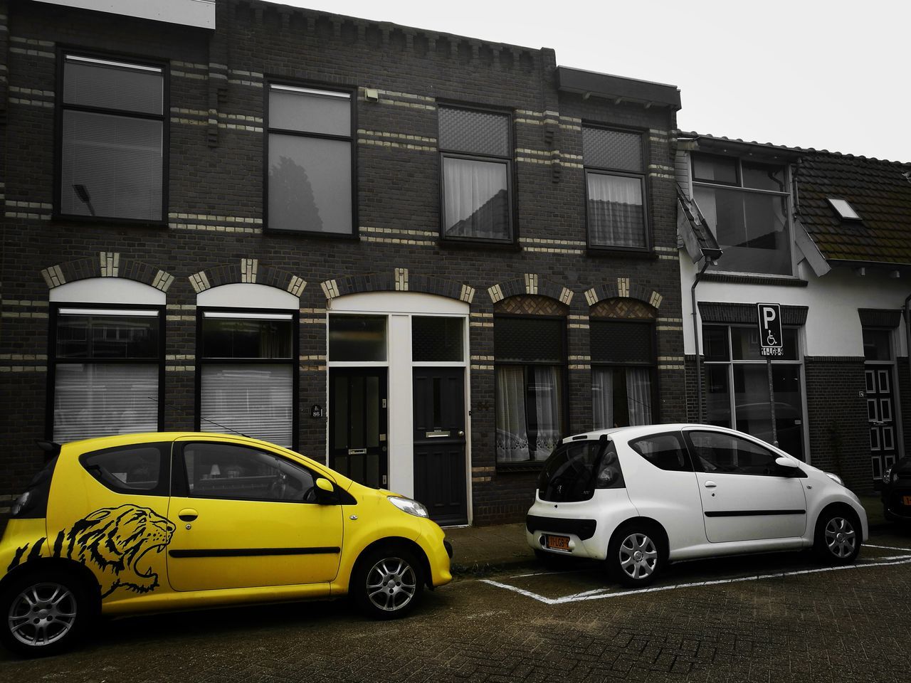 building exterior, architecture, land vehicle, built structure, mode of transport, stationary, parked, parking, yellow, city, day, building, outdoors, no people, parking lot, sky, blue