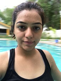 Portrait of smiling young woman in swimming pool