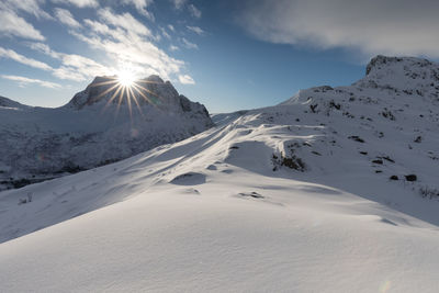 Scenic view of snow covered mountains against sky