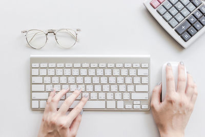 Low section of person using laptop on table