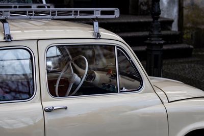 Reflection of man sitting in car