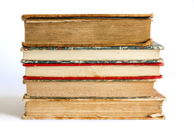 Close-up of stack of books against white background