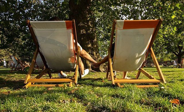 EMPTY CHAIRS AND TABLES IN PARK