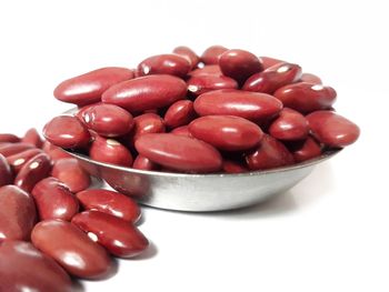 High angle view of cherries in bowl against white background