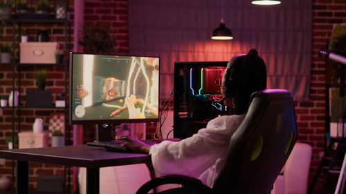 Rear view of woman sitting in cafe