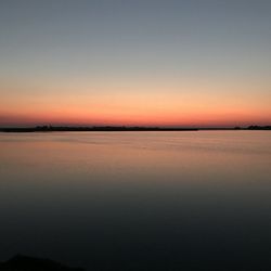 Scenic view of sea against romantic sky at sunset