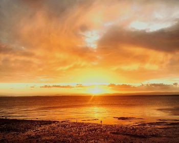 Scenic view of sea against romantic sky at sunset