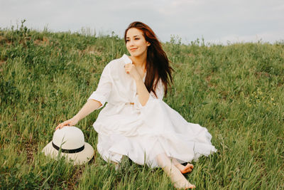 Young woman smiling on field