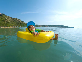 Cute girl relaxing on inflatable ring in sea