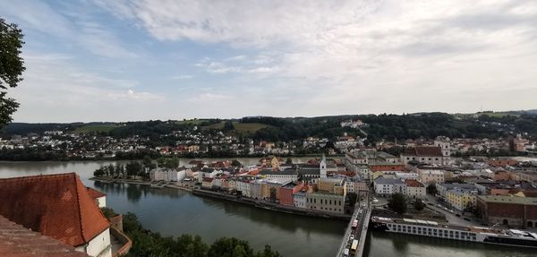 High angle view of river by buildings against sky