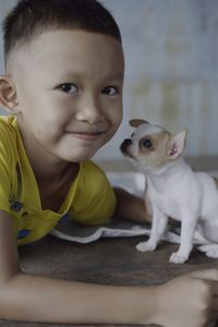 Portrait of cute boy smiling with dog