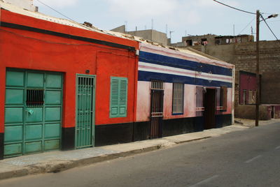 Red road against buildings in city