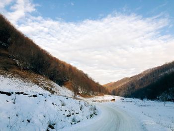 Snow covered field against sky