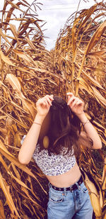 Midsection of woman standing in farm