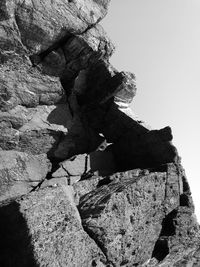 Low angle view of rock formation against sky