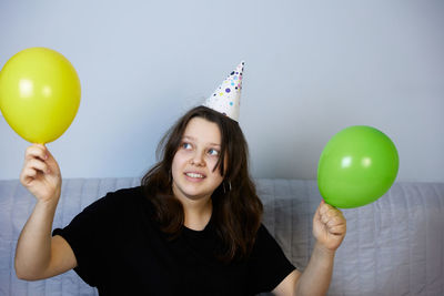 Children have fun playing, blowing up colorful balloons, at a birthday party