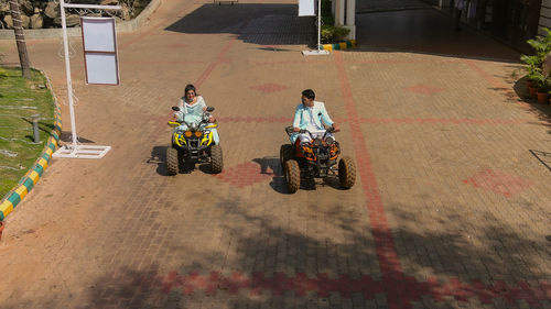 High angle view of people riding motorcycle on road