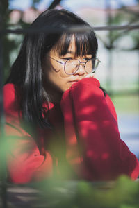 Thoughtful girl sitting outdoors