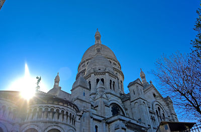 Low angle view of historical building against blue sky