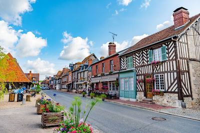 Street amidst buildings against sky