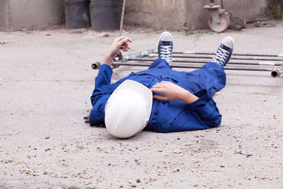 Rear view of boy sitting on land