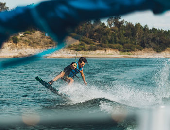 Full length of man doing wakeboard in a lake