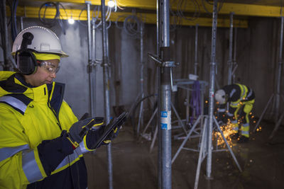 Engineer at building site using digital tablet