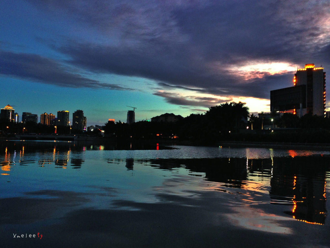 water, sky, building exterior, cloud - sky, sunset, reflection, architecture, waterfront, built structure, city, illuminated, cloudy, silhouette, dusk, river, lake, cloud, dramatic sky, weather, scenics