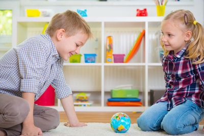 Smiling kids playing at home