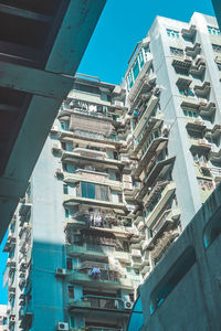 Low angle view of buildings against clear blue sky