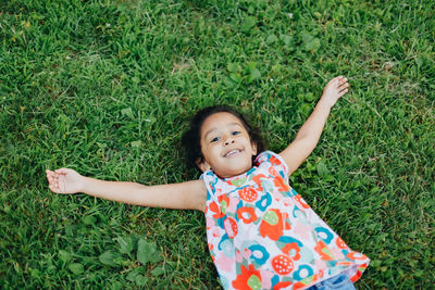 Portrait of cute girl standing on grassy field