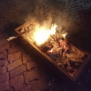 High angle view of fire on barbecue grill