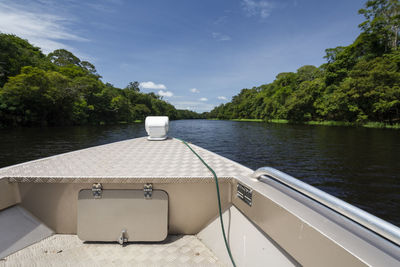 Typical amazon rainforest and river landscape with small speed boat