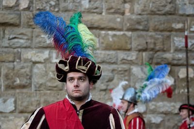 Portrait of man wearing multi colored feathers