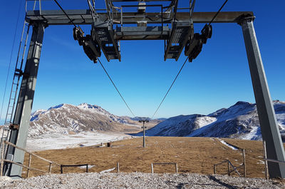 Low angle view of ski lift against sky