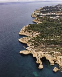 High angle view of rocks on sea shore