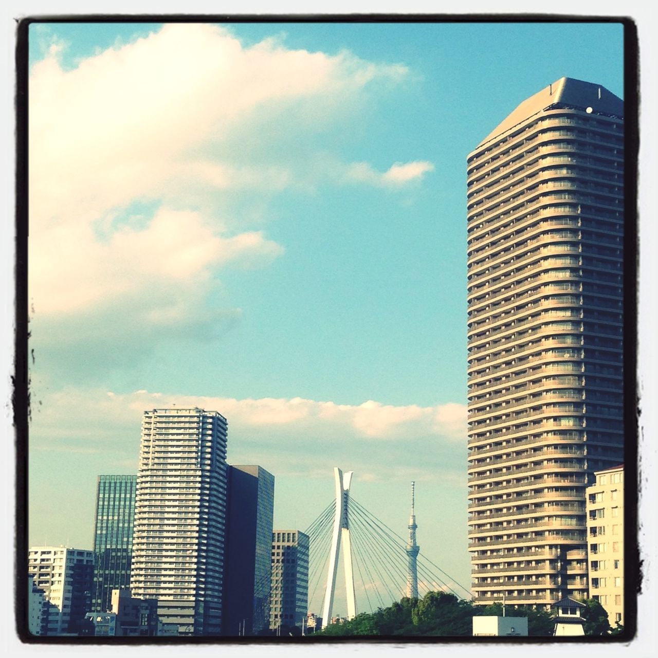 building exterior, architecture, skyscraper, city, built structure, office building, modern, tall - high, sky, tower, cloud - sky, low angle view, building, financial district, urban skyline, cloud, city life, tall, cityscape, skyline