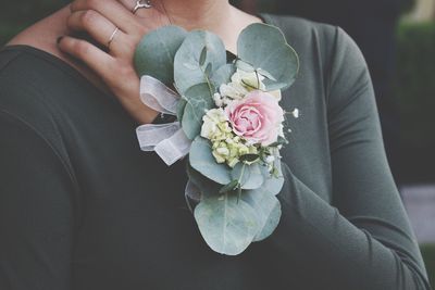 Close-up of hand with corsage