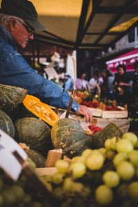 Midsection of man at market stall