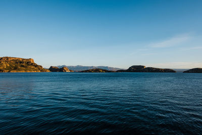 Scenic view of sea against clear blue sky