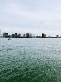 Scenic view of sea and buildings against sky