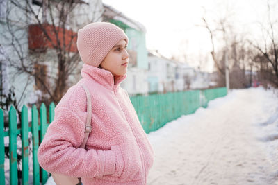 Girl in spring in warm pink clothes