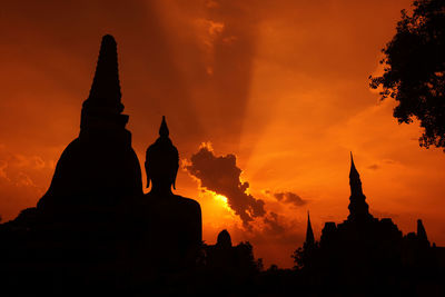 Silhouette temple against sky during sunset