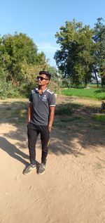 Young man looking away while standing on land