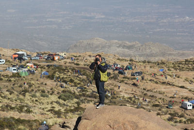 Full length of woman photographing on land