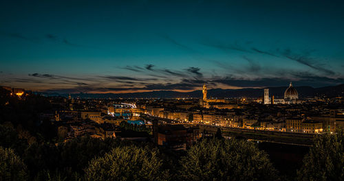 High angle view of illuminated buildings against sky at night
