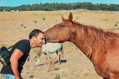 Man looking at horse