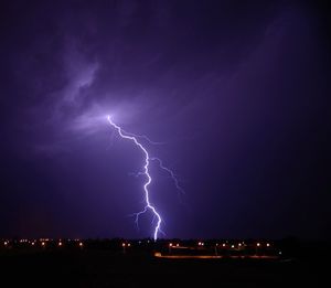 Lightning over landscape at night